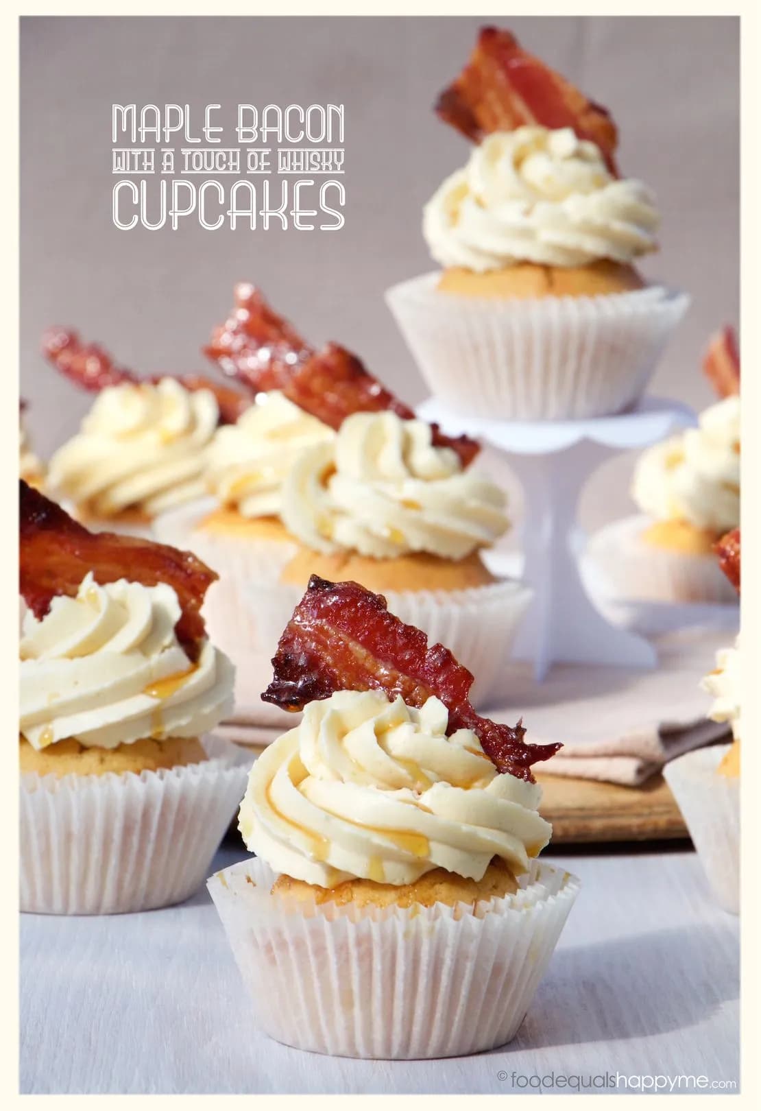 Boozy maple bacon whiskey cupcakes topped with candied bacon and whiskey buttercream frosting